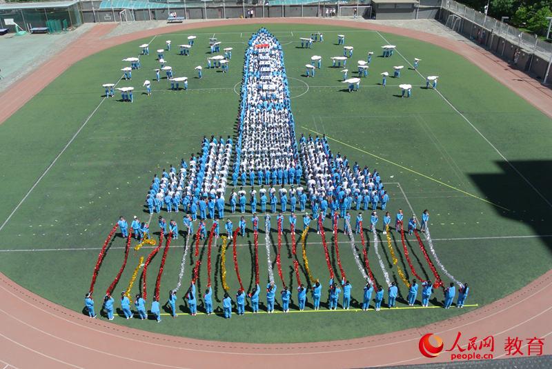 學生們用隊列造型展示神舟飛船從發(fā)射到返回的全過程 郝孟佳/攝